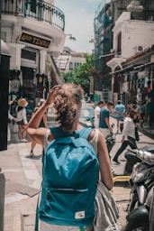 a group of people walking on a city street