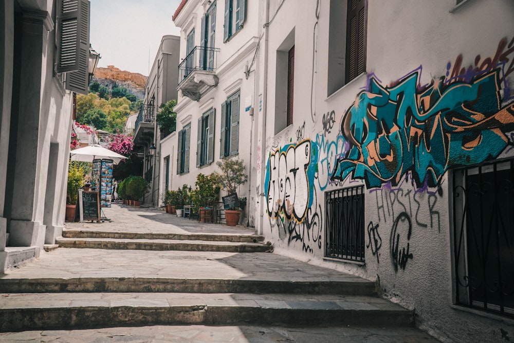 a building with graffiti on the side of the street