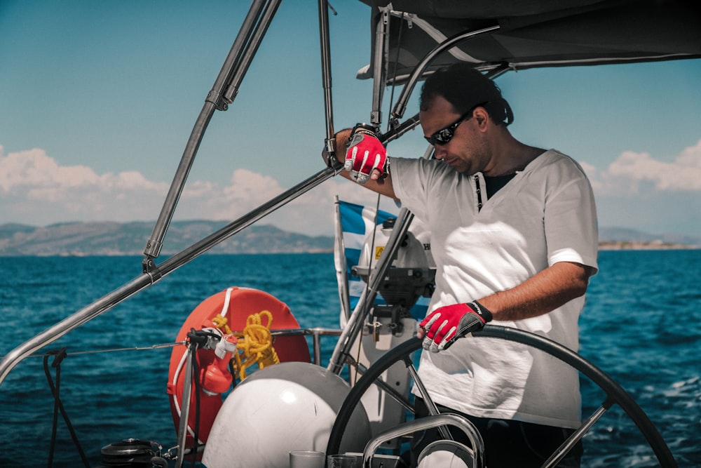 a man riding on the back of a boat in a body of water