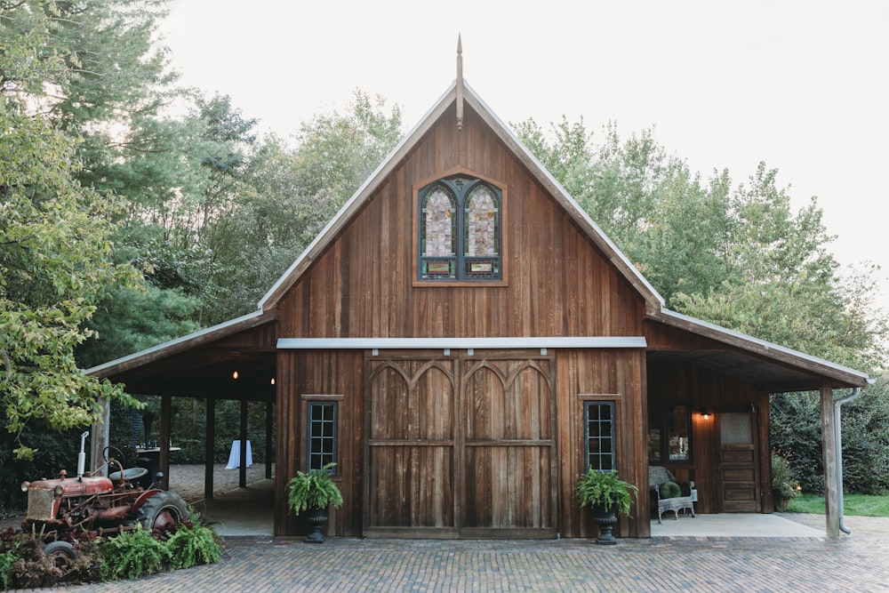 a large brick building with a clock at the top of a wooden house