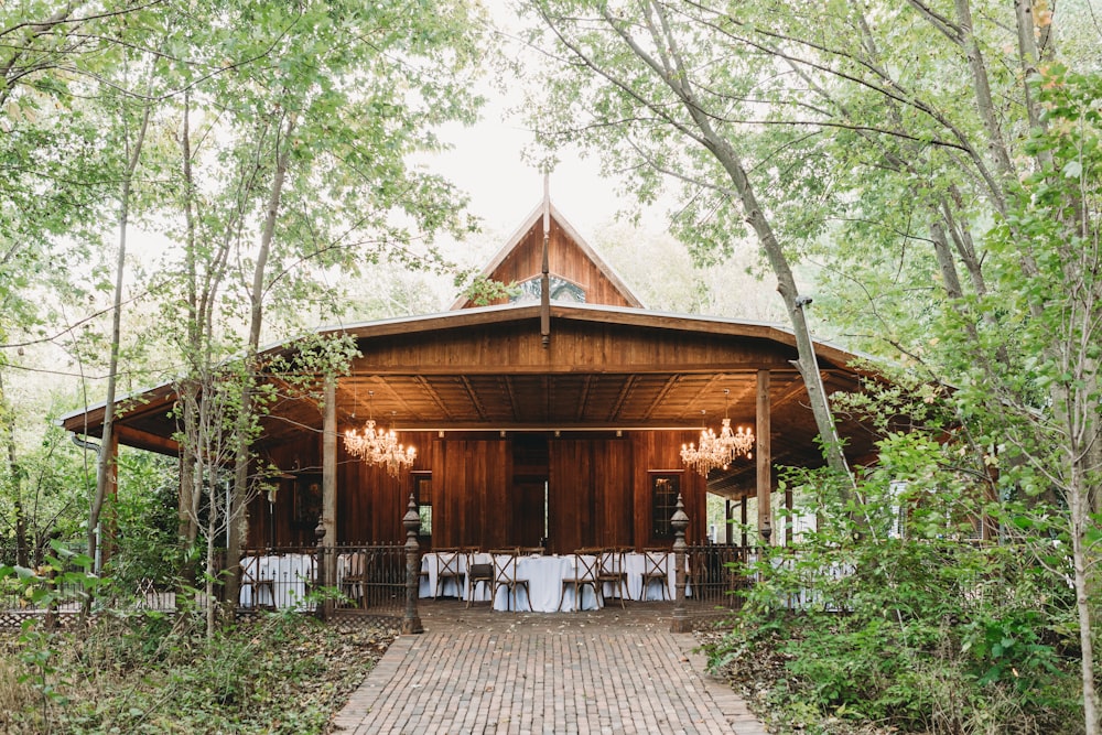 a wooden building surrounded by trees and greenery