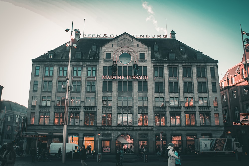 a large building with people walking around in front of it