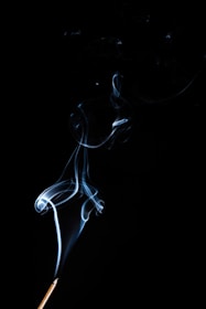 a lit matchstick with smoke coming out of it