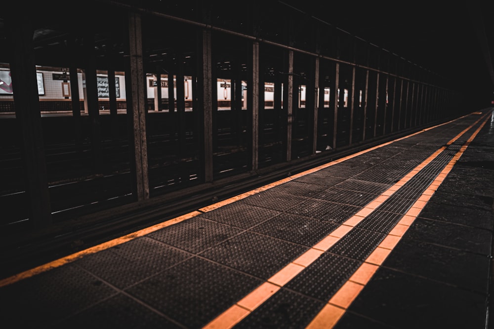 a train traveling down train tracks next to a platform