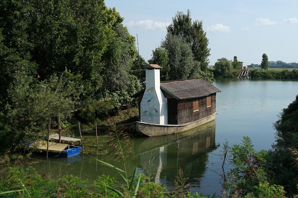 a small house sitting on the side of a river