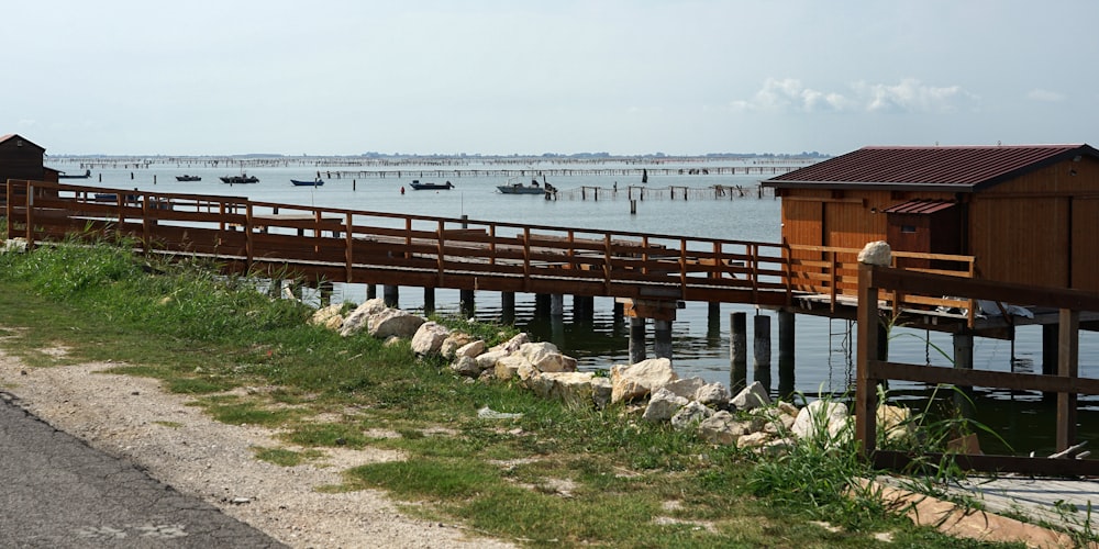 a wooden dock with boats in the water