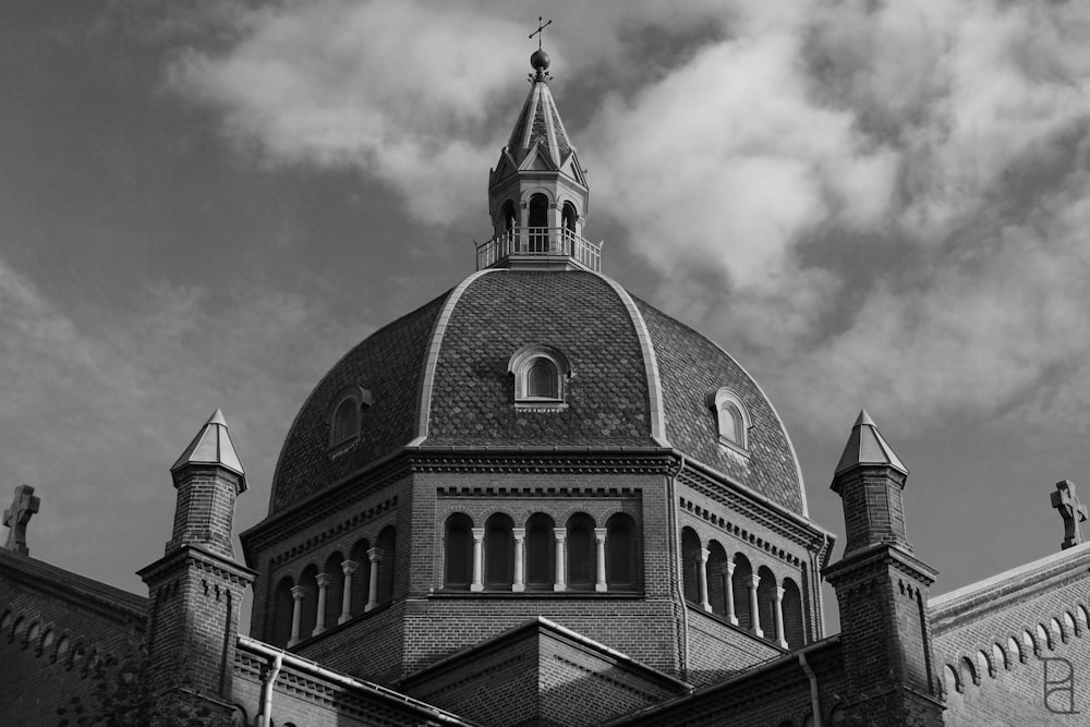 a black and white photo of a building with a steeple