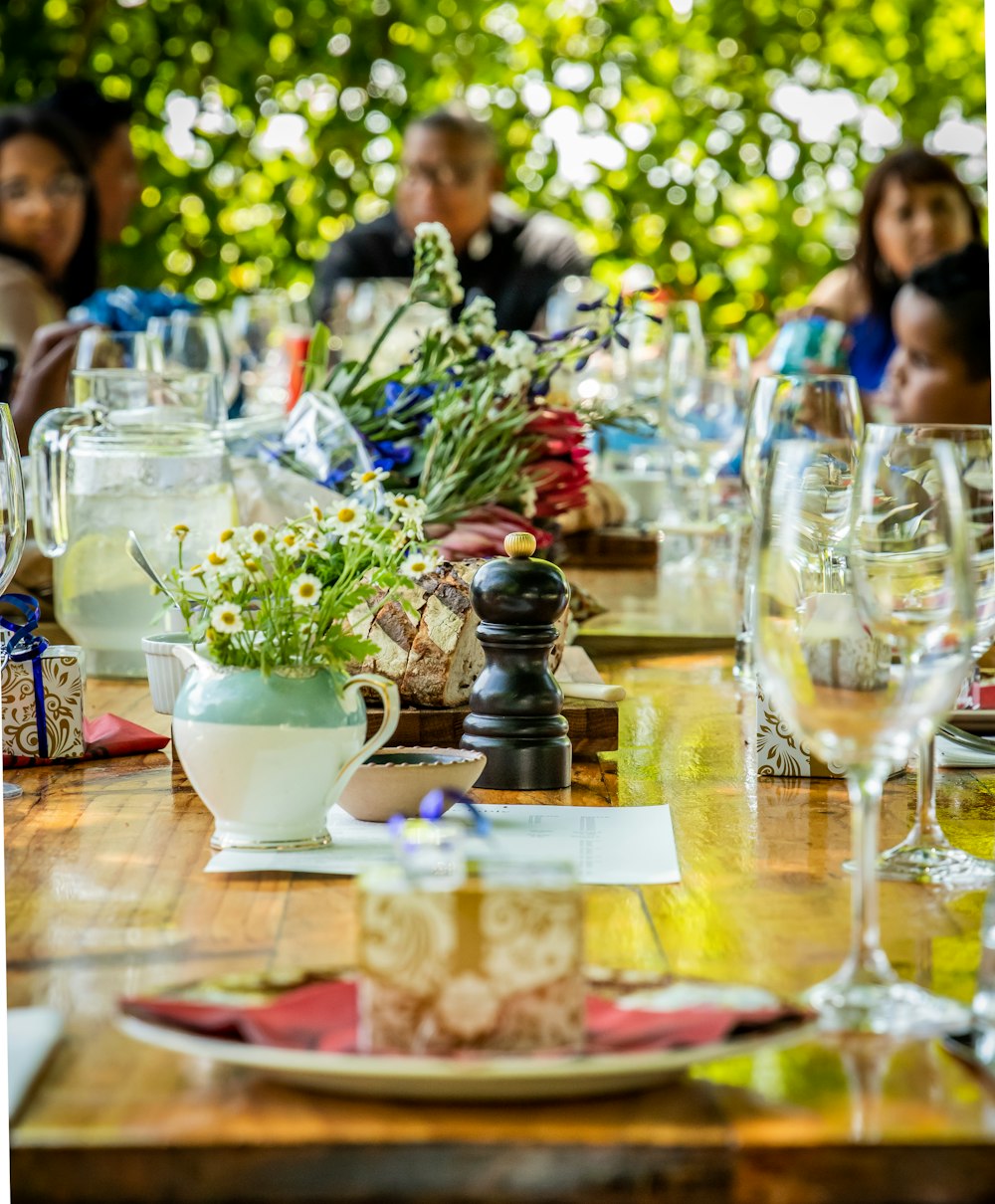 a group of people sitting around a wooden table