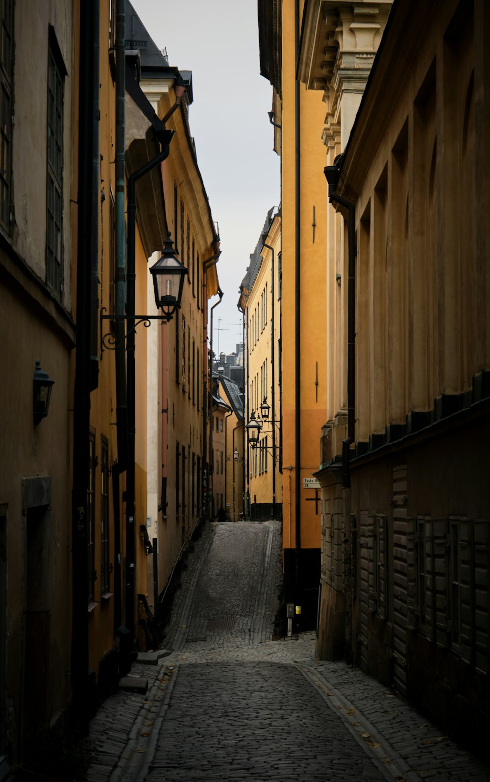 a narrow cobblestone street in a european city