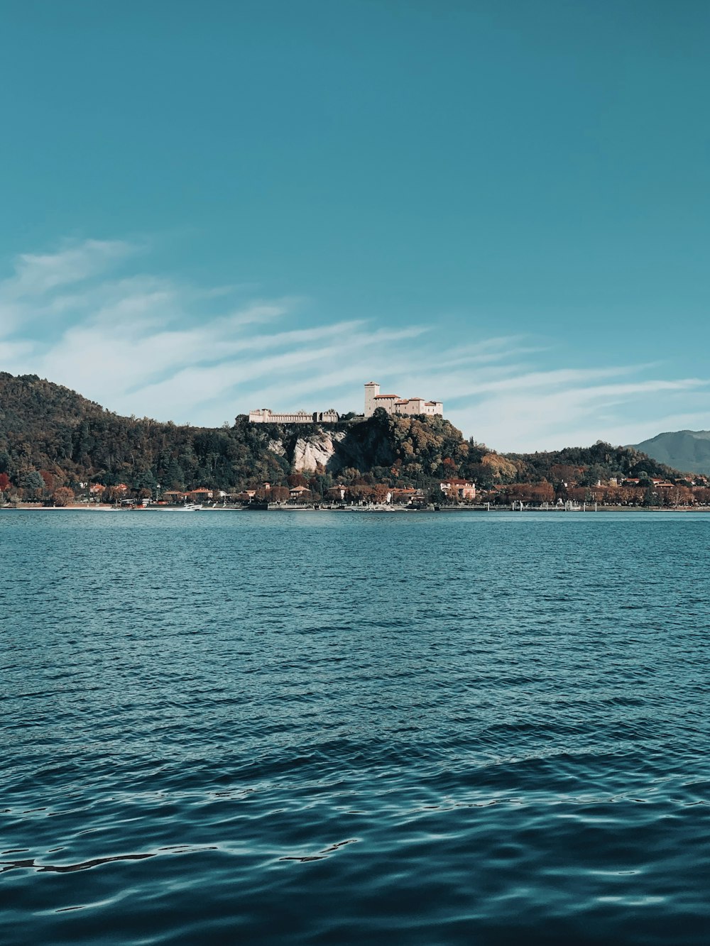 a large body of water with a small island in the background