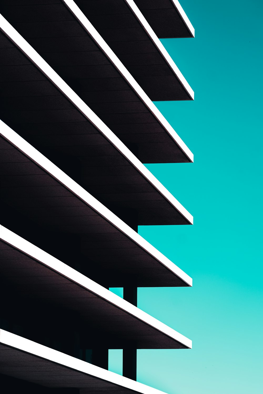 a tall building with balconies against a blue sky