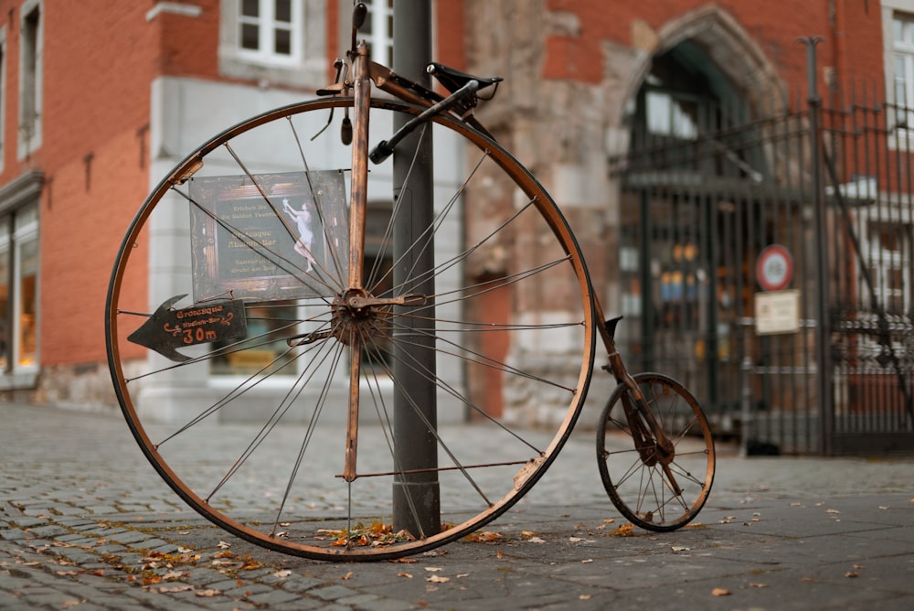 an old bicycle is chained to a pole