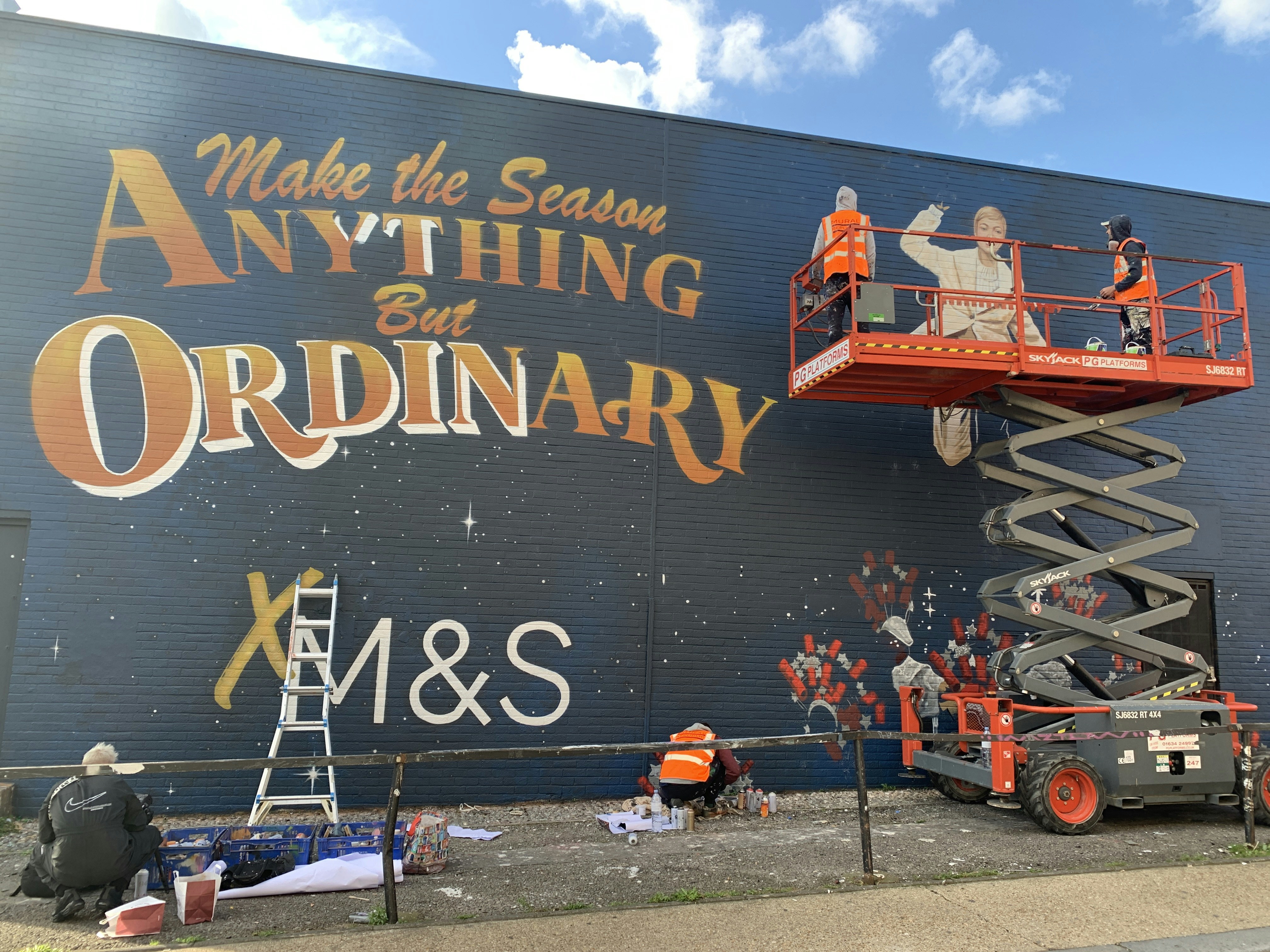 a man is painting a mural on the side of a building