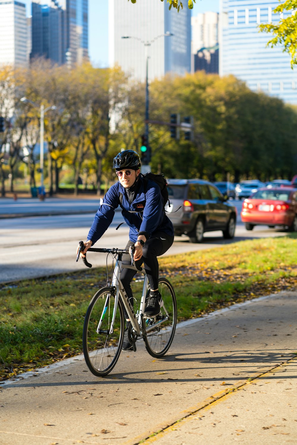 a man riding a bike down a sidewalk