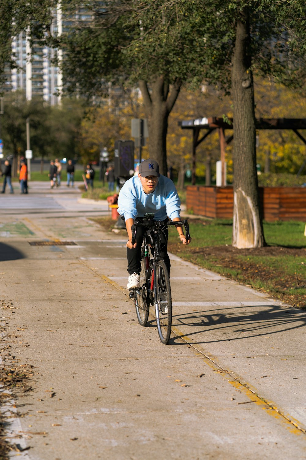 a man riding a bike down a sidewalk
