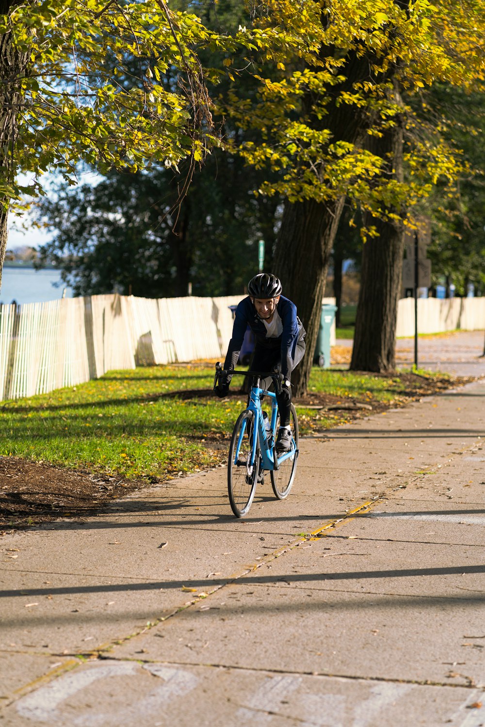 a man riding a bike down a sidewalk