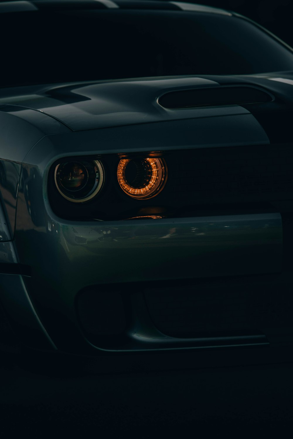 a close up of a car's headlights in the dark