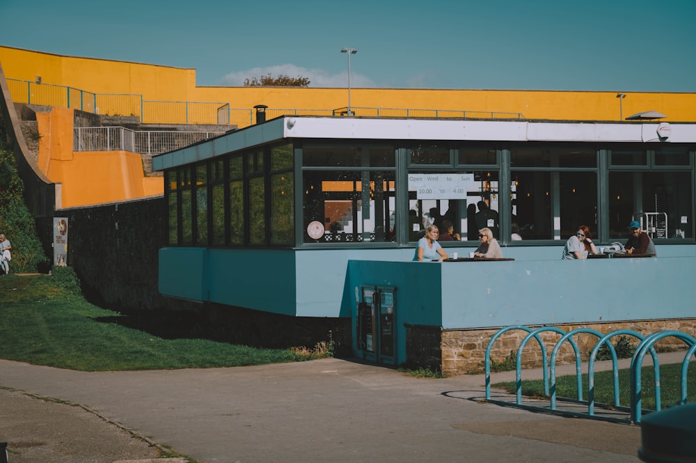 a group of people sitting outside of a building