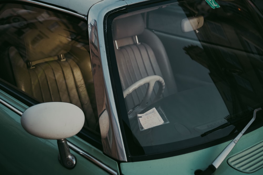 a green car with a white steering wheel