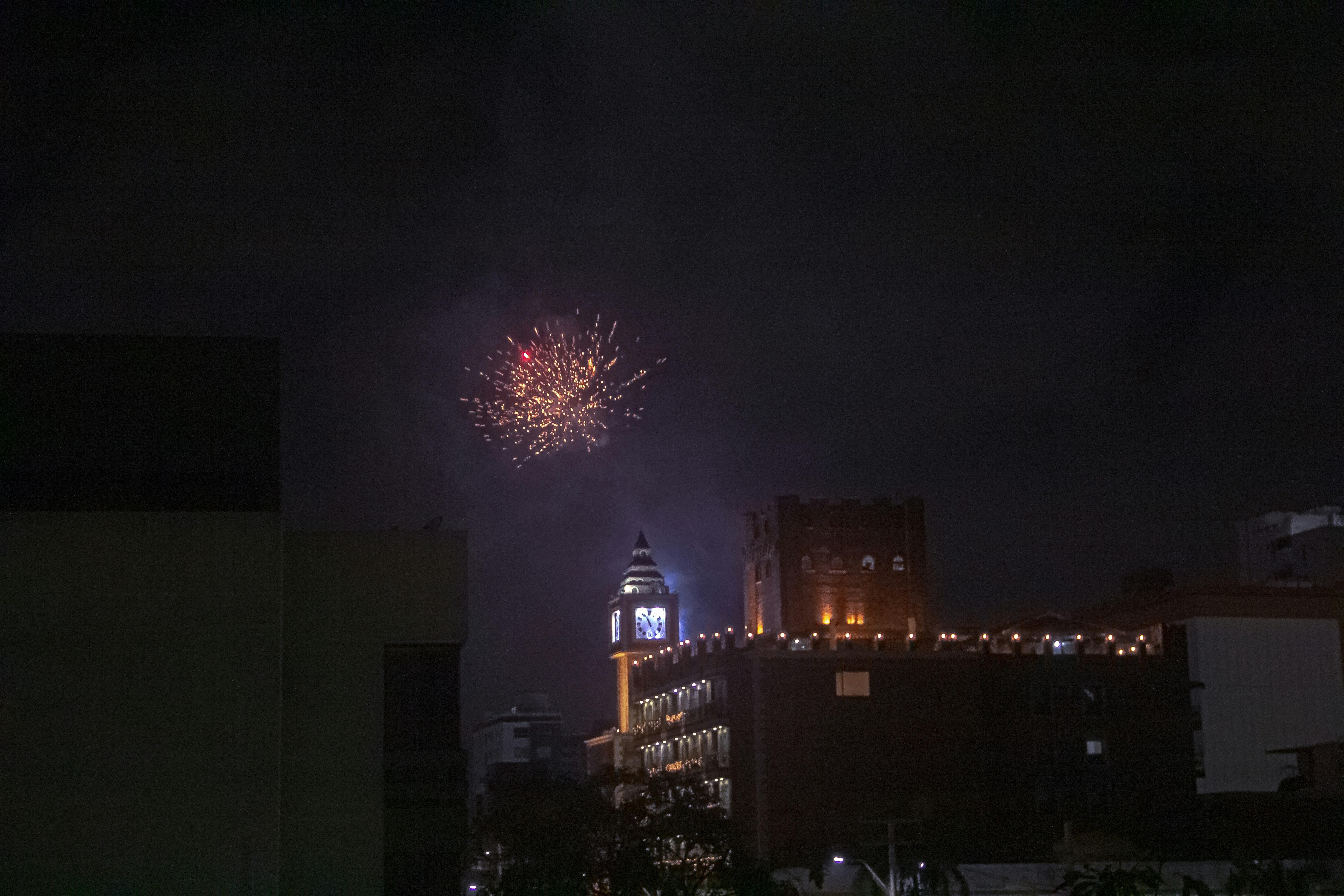 Fireworks are lit up in the night sky above a city photo – Free Grey ...