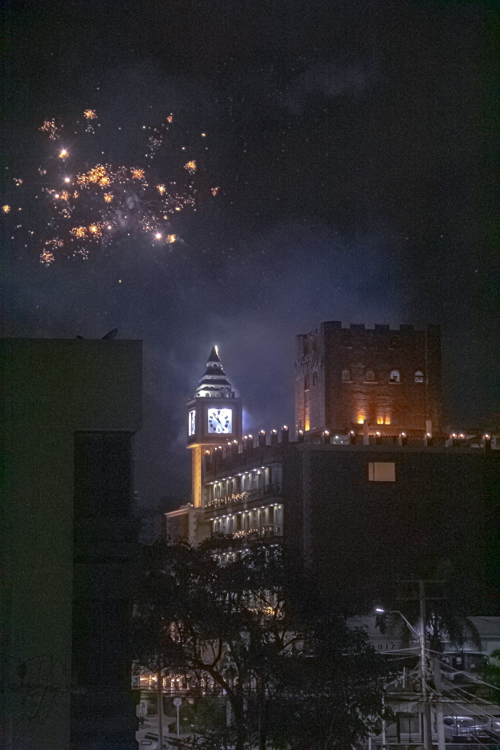 fireworks are lit up in the sky above a city