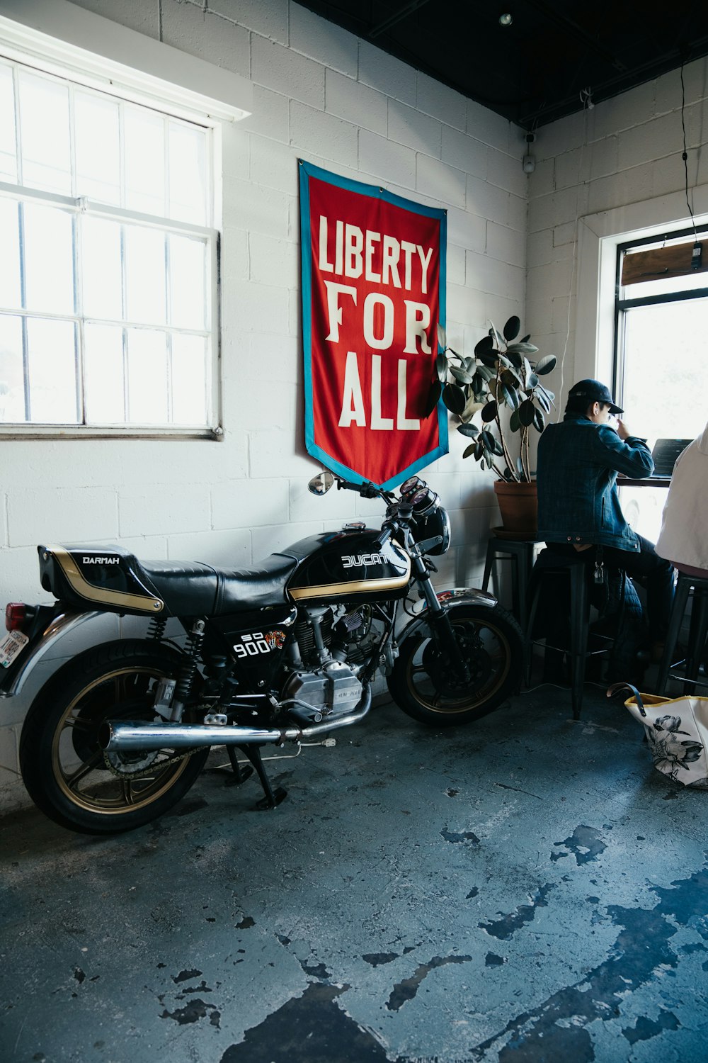 a motorcycle parked next to a window in a room