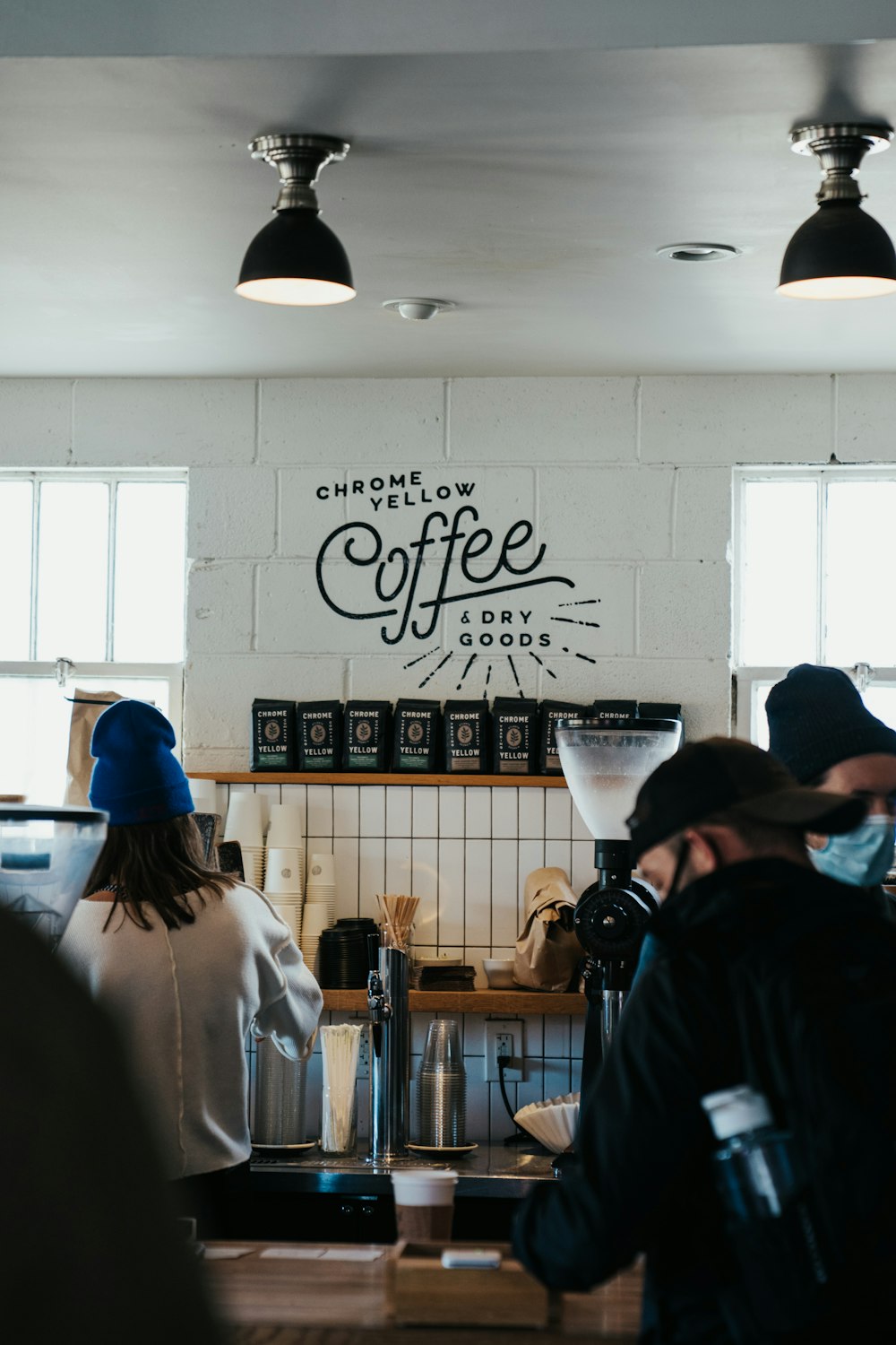 a group of people standing around a coffee shop