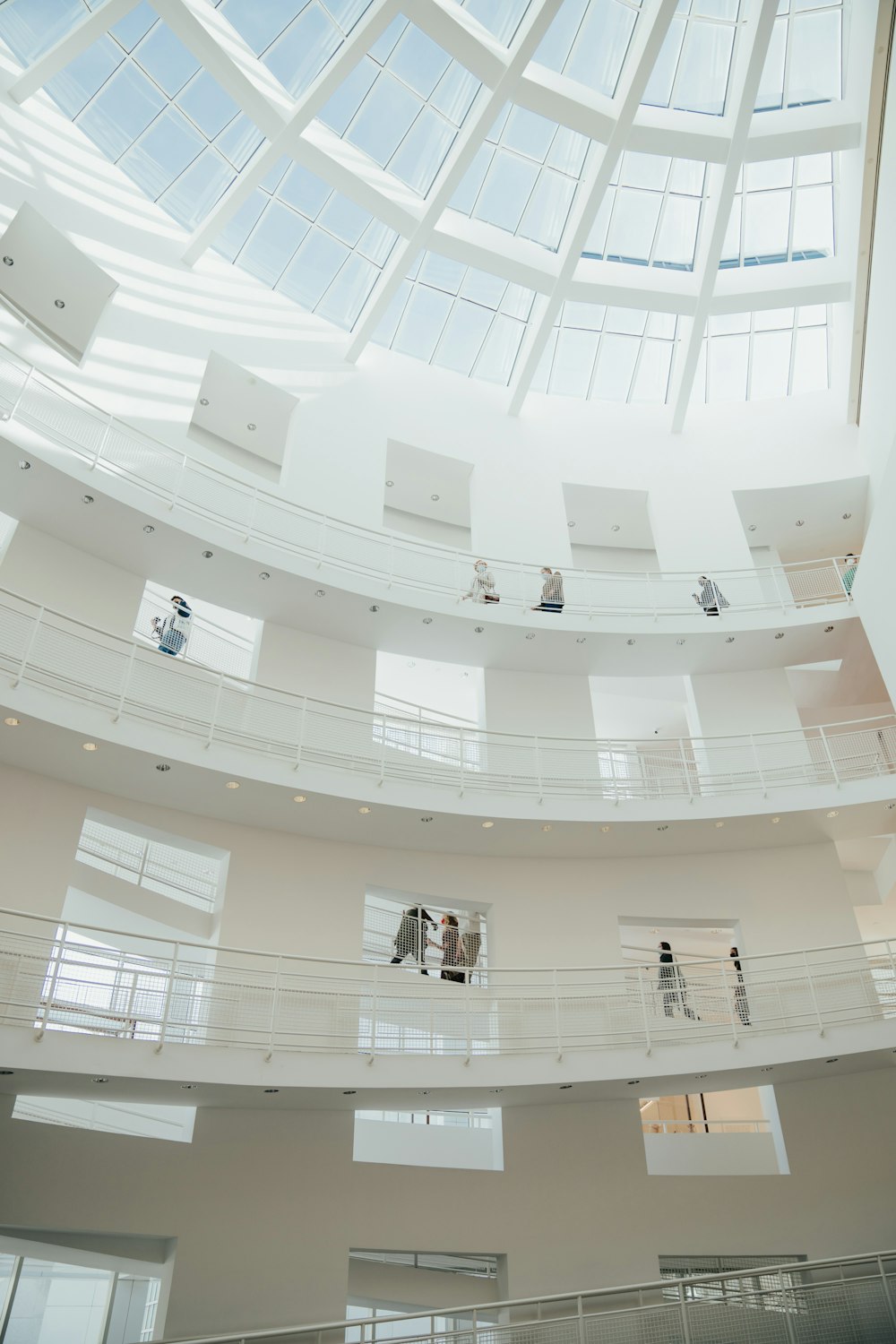 a group of people standing inside of a large building