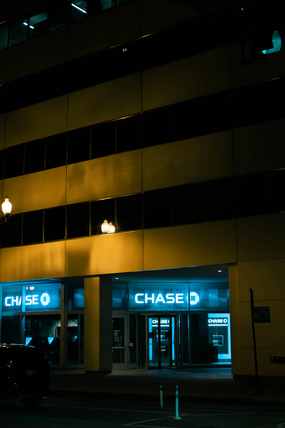 Chase Bank building at night with blue-lit exterior and contrasting yellow facade