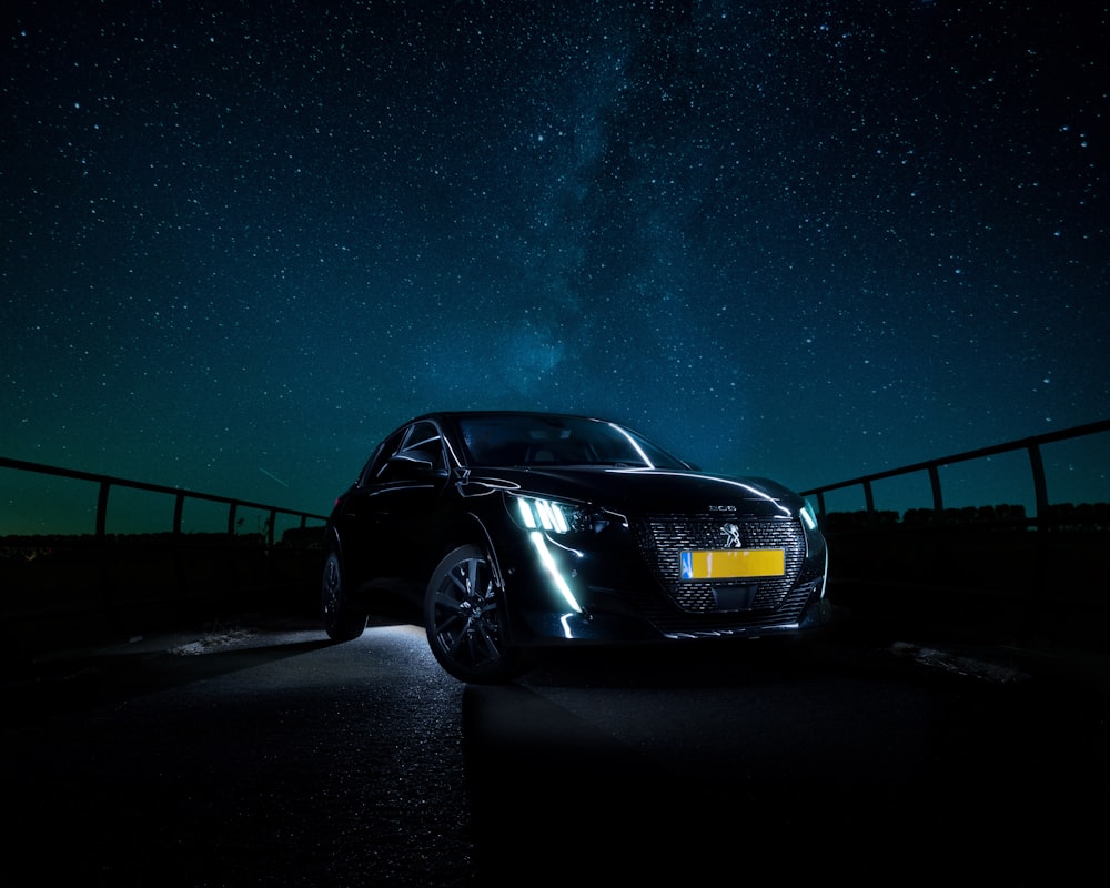 a car parked on the side of a road at night