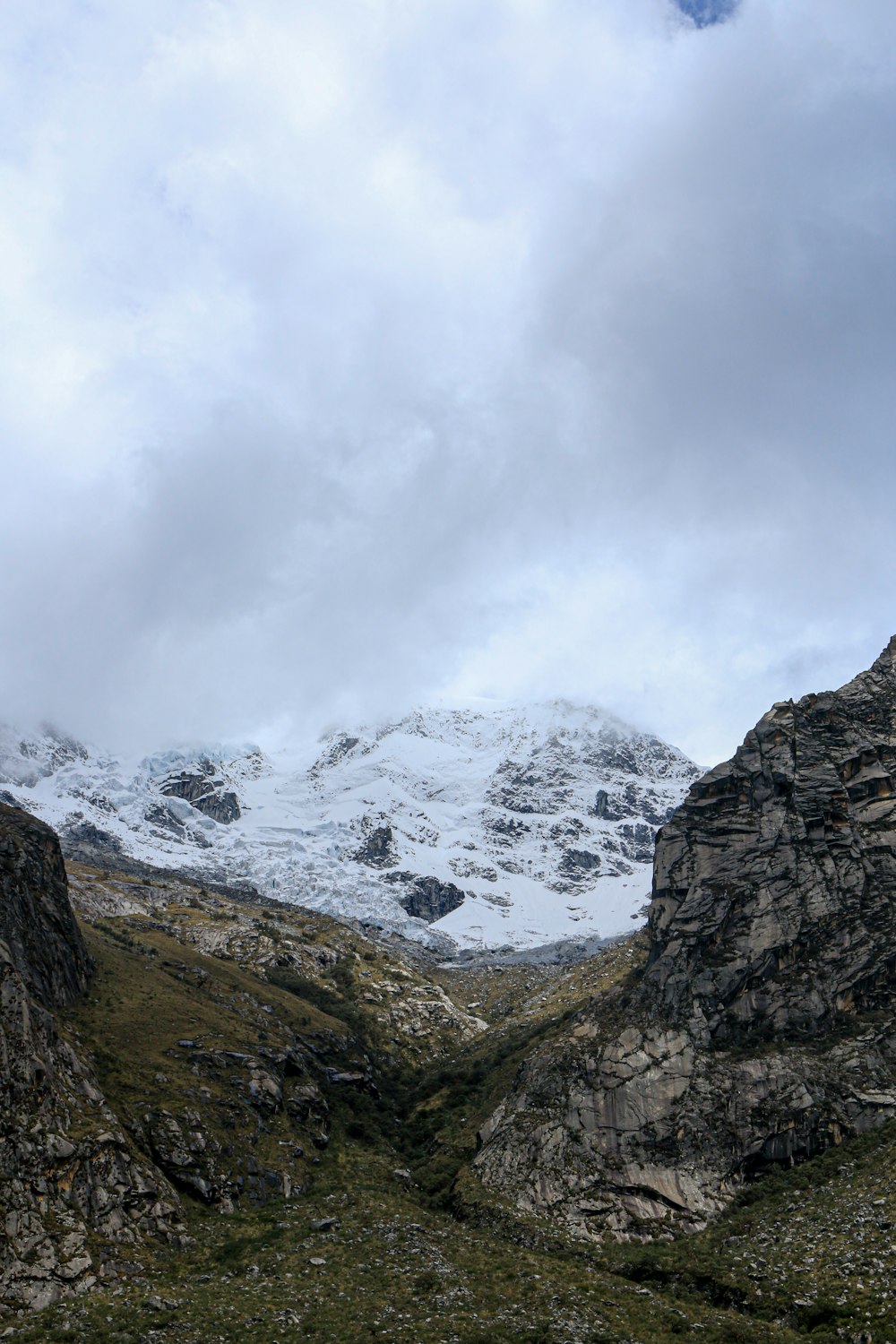 a rocky mountain with snow on the top