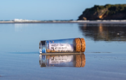 a message in a bottle sitting on the beach