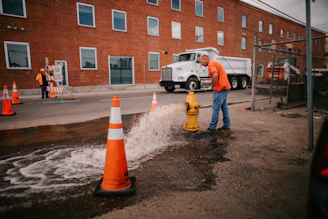 a man standing next to a yellow fire hydrant