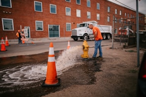a man standing next to a yellow fire hydrant