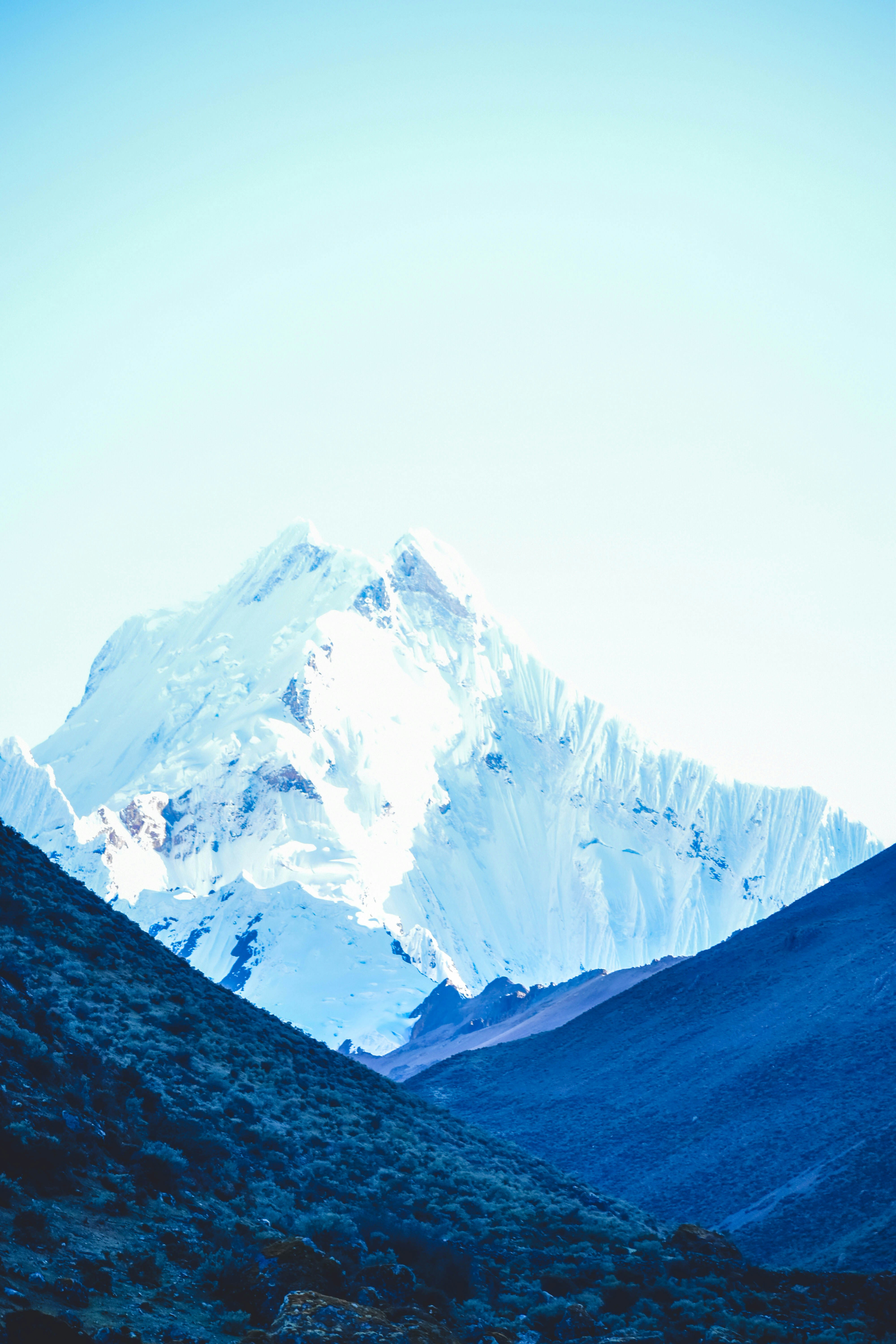 Green Grass Field Near Snow Covered Mountain During Daytime Photo Free Blue Image On Unsplash