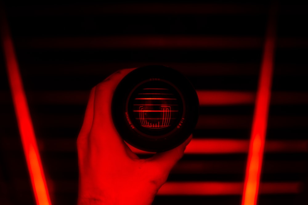 a person holding a red light in their hand