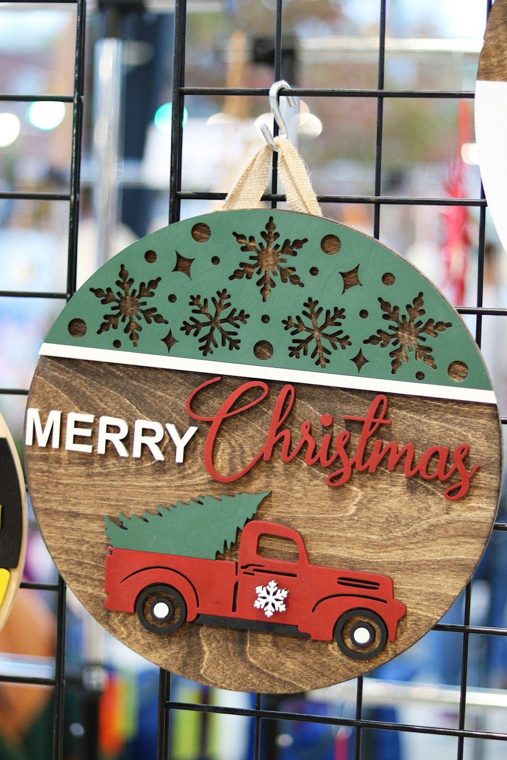 a christmas ornament hanging on a wire fence