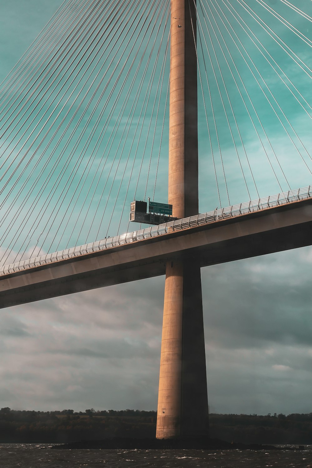 a bridge with a street sign on the side of it