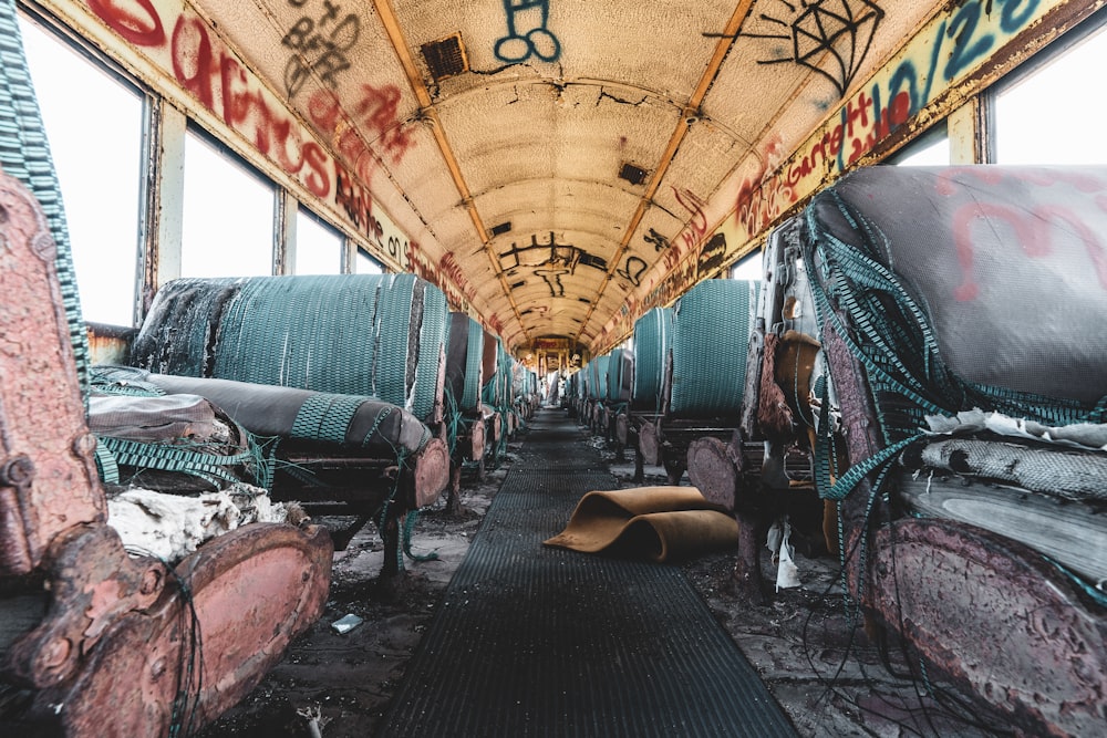 the inside of a covered bus with graffiti on it