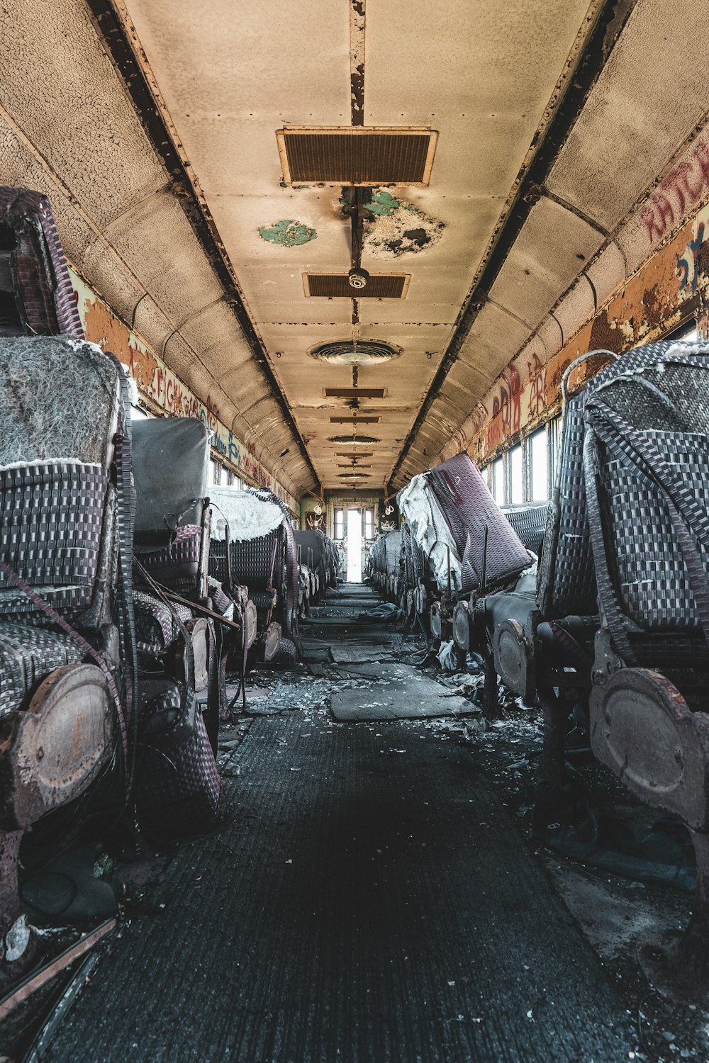 a long hallway with lots of rusted out furniture