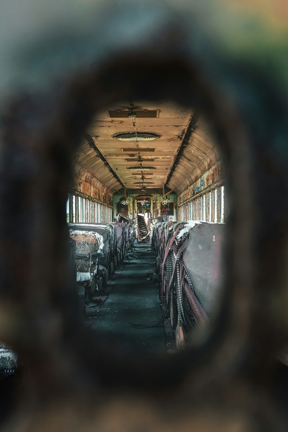 a view of a bus through a hole in the side of the bus