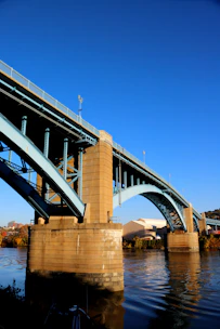 a bridge over a body of water under a blue sky