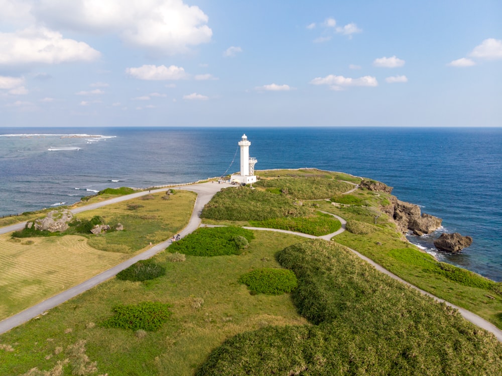 an aerial view of a lighthouse near the ocean