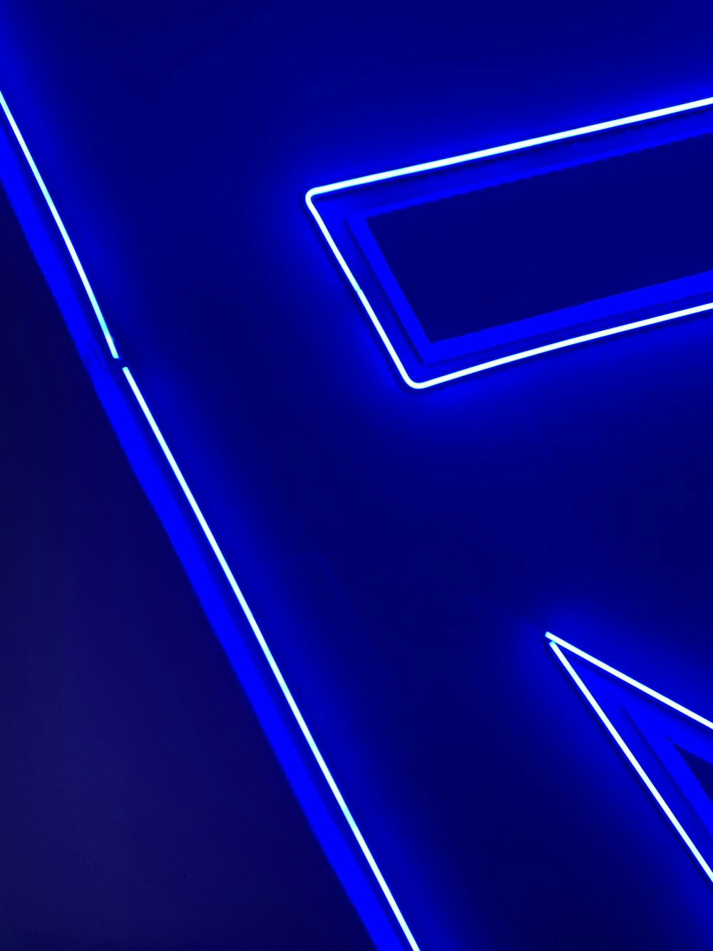 a blue neon sign with arrows pointing in different directions