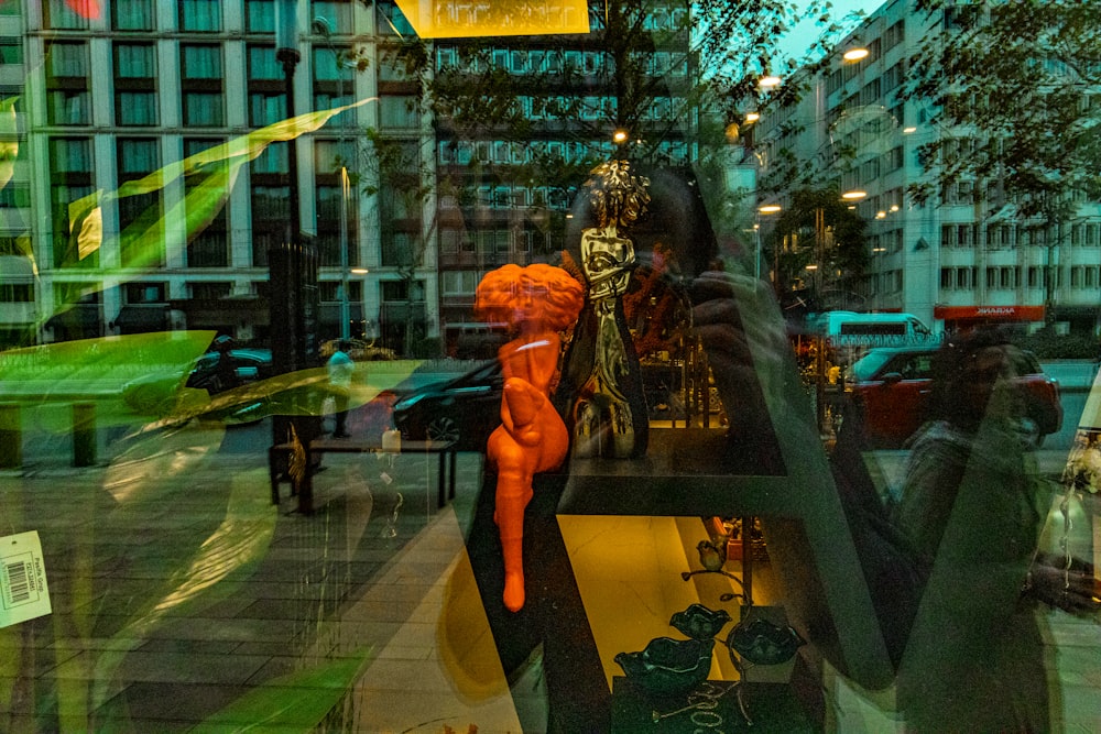 a store window with a mannequin in the window