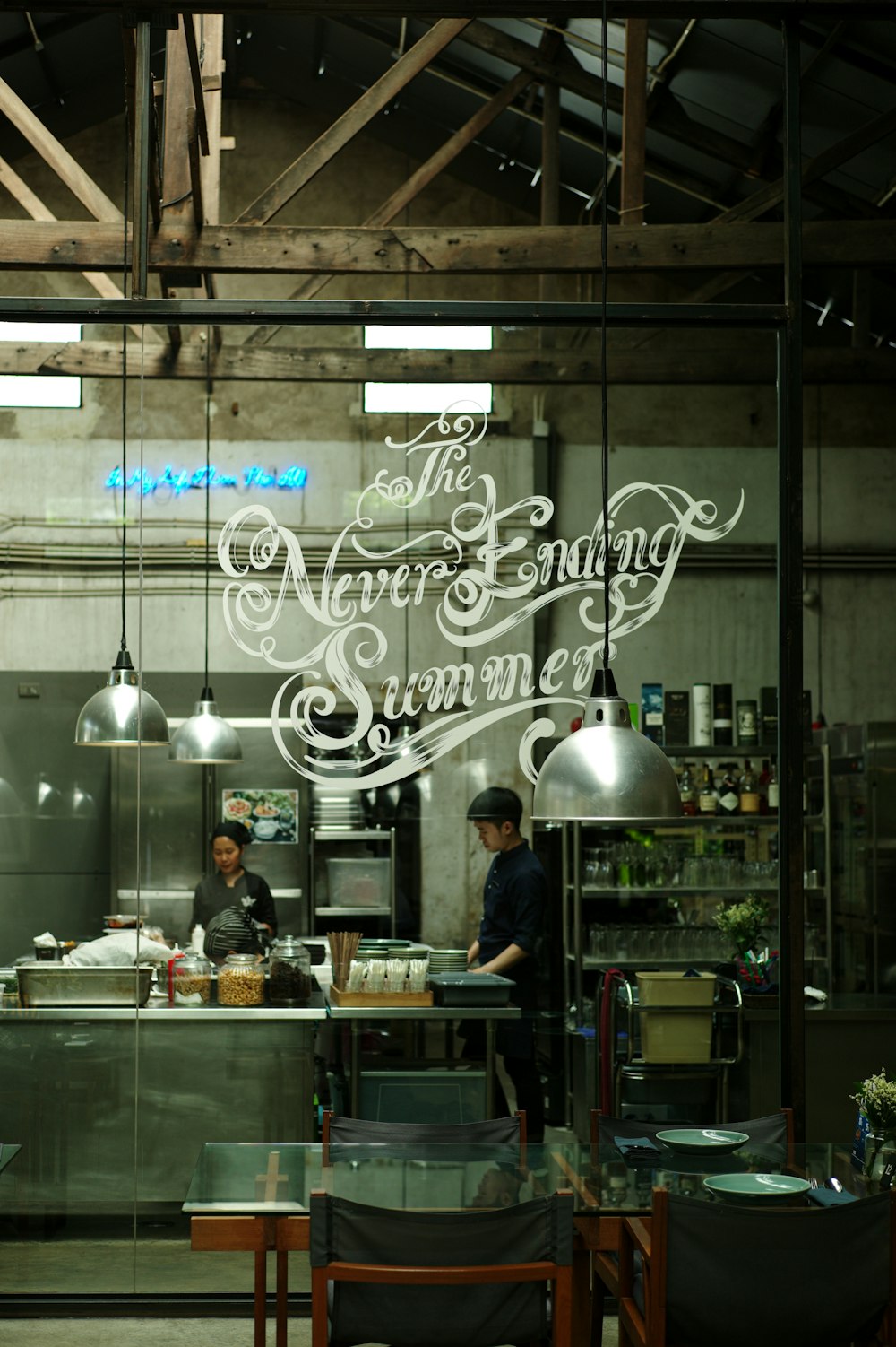 a couple of people that are standing in a kitchen