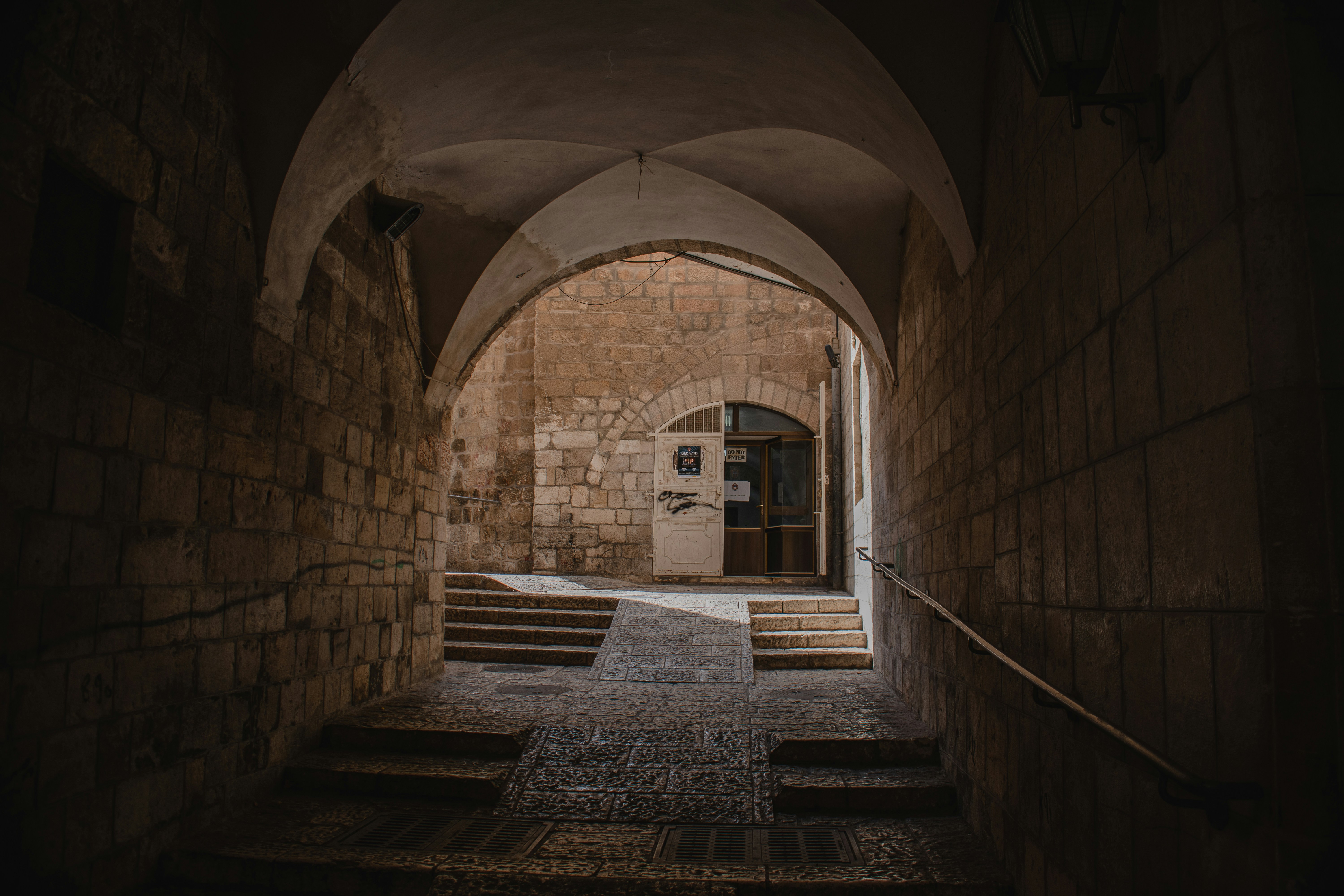 a stone building with steps leading to a door