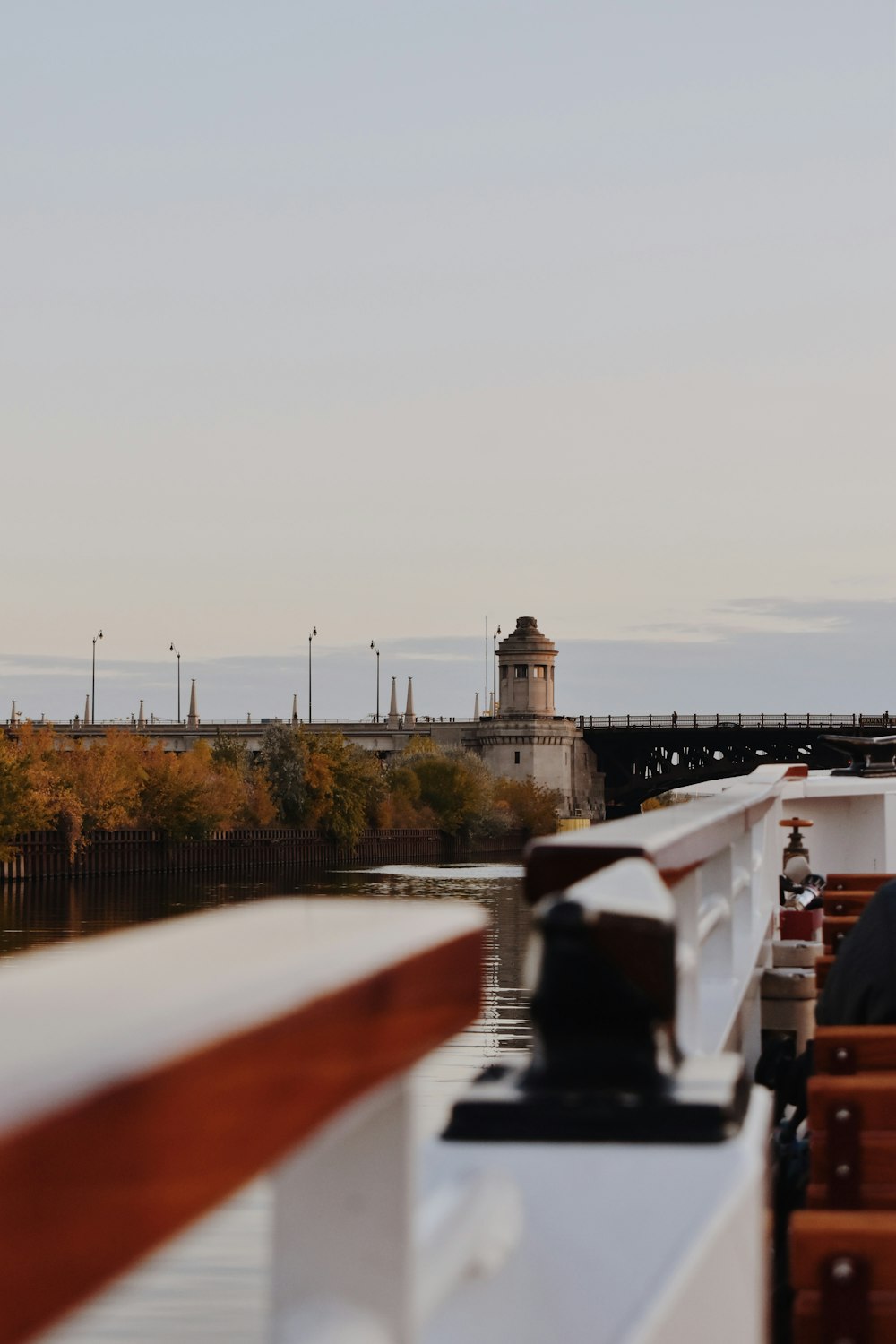 a boat traveling down a river next to a bridge