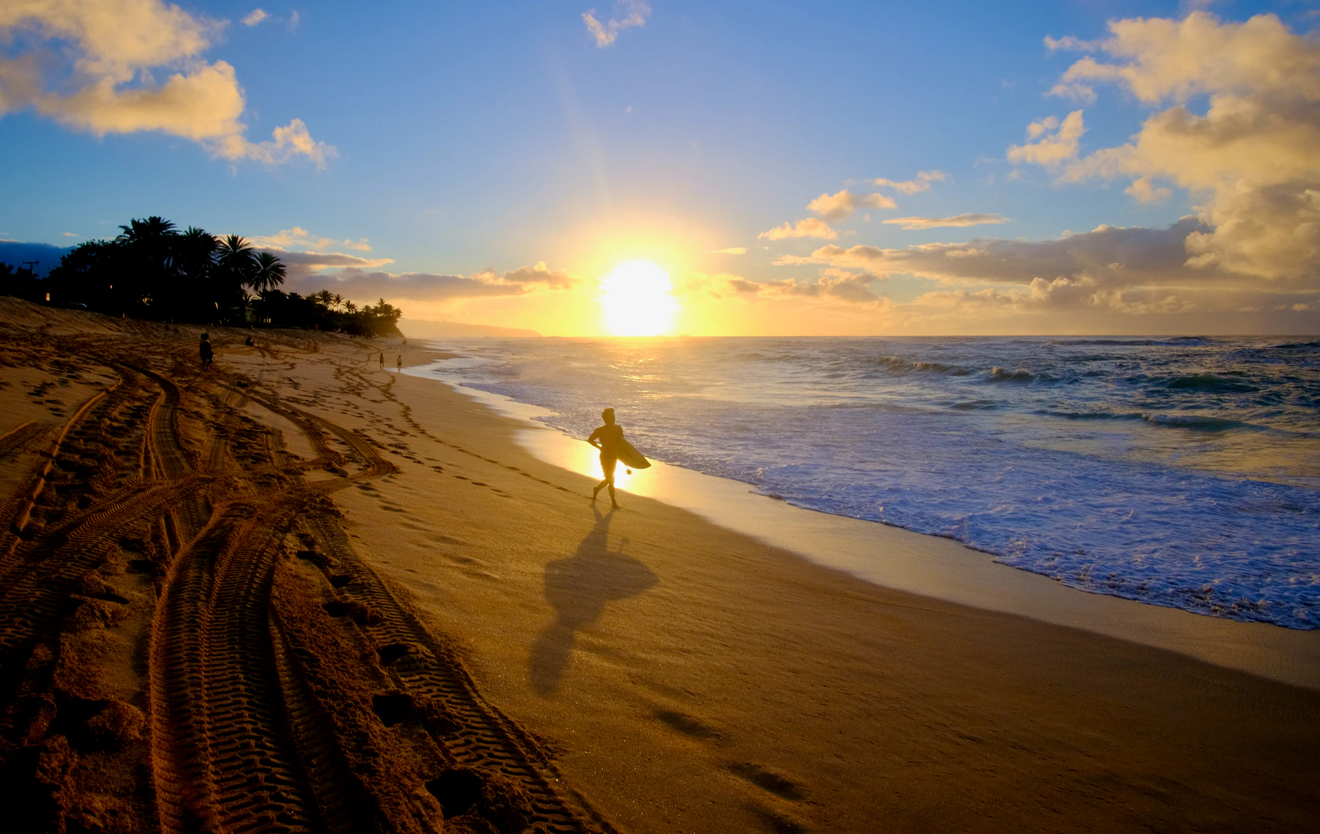 a person with a surfboard is walking on the beach
