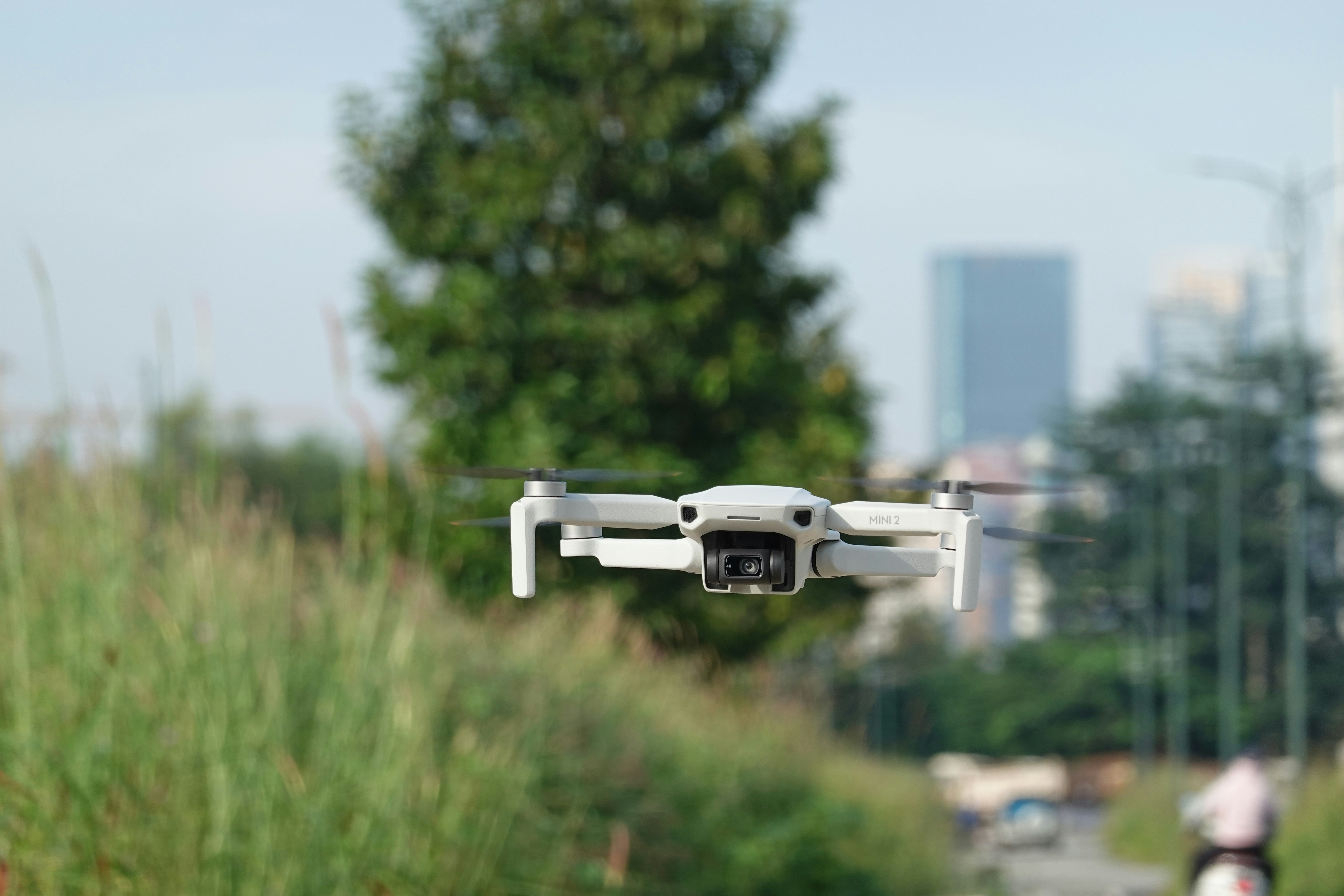 a white remote controlled flying over a street